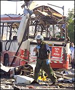 An Israeli soldier at the scene of a rush hour bomb which killed 19 Israelis just before Mrs Blair's controversial remarks