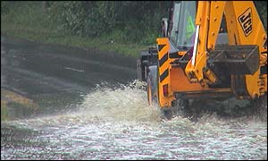 JCB going through flooded road