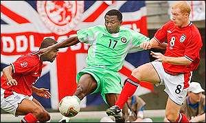 Julius Aghahowa is shadowed by England's Paul Scholes
