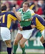 Ireland winger Denis Hickie fails to force his way through against Romania