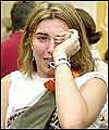 A distressed woman arrives at Sydney International Airport