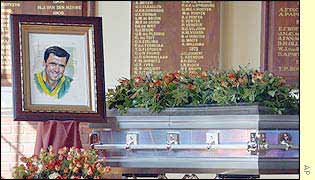 A hand-drawn portrait of Hansie Cronje stood next to his coffin 
