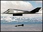 F-117 bomber flying over mountains