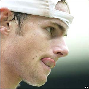 Andy Roddick sticks his tongue out during his defeat to Roger Federer