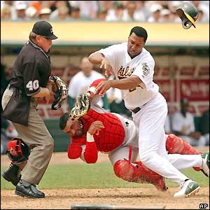 Oakland Athletics Jermaine Dye collides with Anaheim Angels catcher Bengie Molina