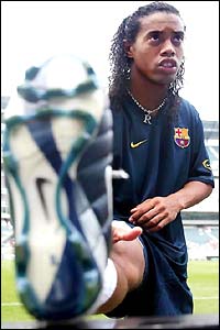 Barcelona's new signing Ronaldinho goes through his stretches in Philadelphia as they prepare for a clash with Man Utd
