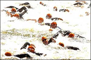 Competitors churn up the water as the London triathlon gets underway