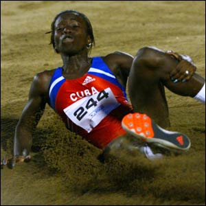 Cuba's Yangelis Savigne lands in the pit while competing in the women's long jump final at the 2003 Pan American Games in San Domingo