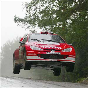 Marcus Gronholm's Peugeot gets airborne as he takes the lead at the Rally of Finland