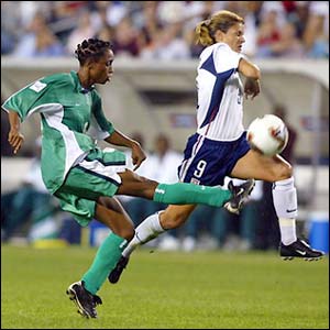 American star Mia Hamm blocks a shot from Nigeria's Kikelomo Ajayi during her side's 5-0 win in the group stages of the women's World Cup