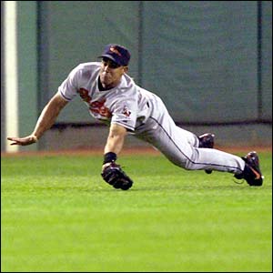 Centre fielder Luis Matos of the Baltimore Orioles makes a diving catch from Boston Red Sox second baseman Damian Jackson at Fenway Park