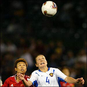 China's Jie Bai and Russia's Marina Saenko keep their eye on the ball in the women's World Cup