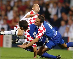 Michael Owen collides with two Croatian players during Wednesday night's friendly match