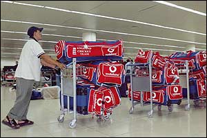 A local porter struggles with all of the England cricket team kit at Dhaka airport