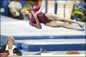 A judge watches Russia's Svetlana Khorkina as she wins gold in the women's individual all-round final at the World Gymnastics Championships 