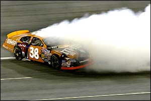 Elliott Sadler spins in his Ford on turn four of the Lowe's Motor Speedway in Concord, North Carolina during the UAW-GM Quality 500 