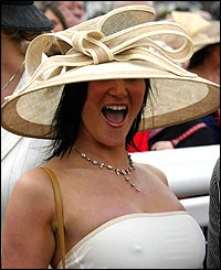 A racegoer queues