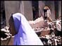Nigerian woman walks past burnt-out church