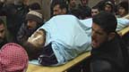 Mourners carry body