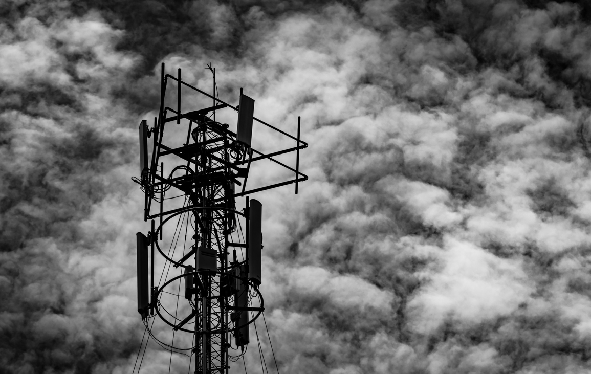 Image of an antenna array against a dark cloudy backdrop