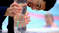 Dr Yan controls the movement of the straw submarine.