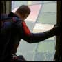Man looking out of open plane door