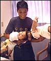 One-year-olds Maria de Jesus and Maria Teresa Quiej are held by their father Wenceslao 