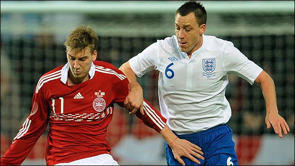 Terry takes on Denmark's Nicklas Bendtner