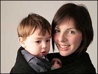 Woman holding a two year old boy.