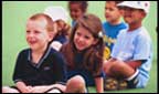 Children sitting correctly on the floor.