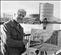 Jim Leckey, pictured in a newspaper with one of his many paintings, this one of Belfast Gasometers, now gone.