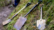 Spades and a shovel lying on the ground