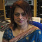 Rozana holding the photograph of her first meeting with the Queen