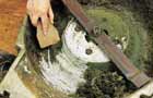 Use a stiff bursh to remove old grass clippings