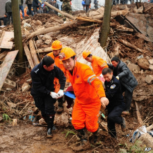 云南镇雄高坡村山体滑坡现场救援人员搬运一具遇难者遗体(11/1/2013)