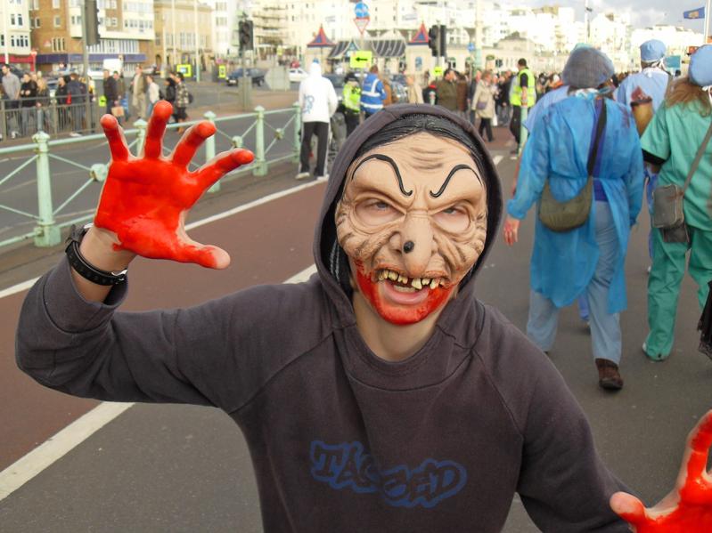 a young boy with a frightening Halloween mask on