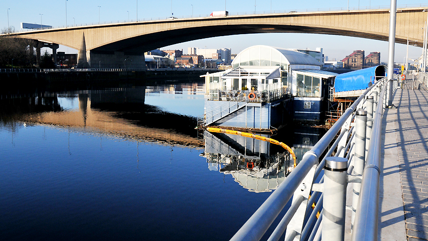 View of the Renfrew Ferry underneath the Kingston Bridge over the River Clyde, Glasgow.