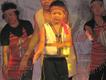 A young child performs a traditional song