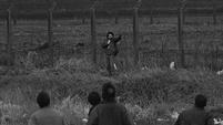 Michael Stone shoots towards mourners at Milltown Cemetery (Pacemaker Press Intl)