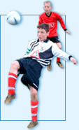 Young children playing football.