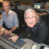 Always keen to learn, Paul gets a lesson in driving the desk on the other side of the glass...