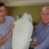Paul and studio manager John, admire a tank top, knitted and sent in by regular listener Elsie Toms.