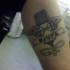 Microphone with wings tattoo
