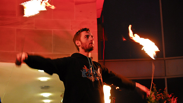 Flame thrower performing on the steps of the Royal Concert Hall.