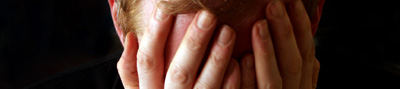 A man hiding his face