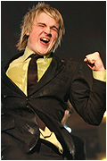 Tom for McFly celebrates on winning their award 