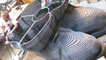 A member of Sebastien Boyesen's team welding the boots of the sculpture