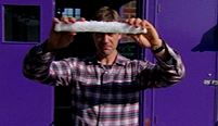 Jem throws a bar of pykrete in the 'impact' test.