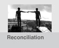 Image of statue in Derry of two figures reaching to shake hands