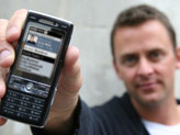Scott Mills with a mobile phone
